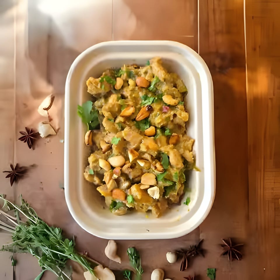 Kolapasi Indian Canteen's Indian dish, a creamy curry topped with nuts and fresh cilantro.