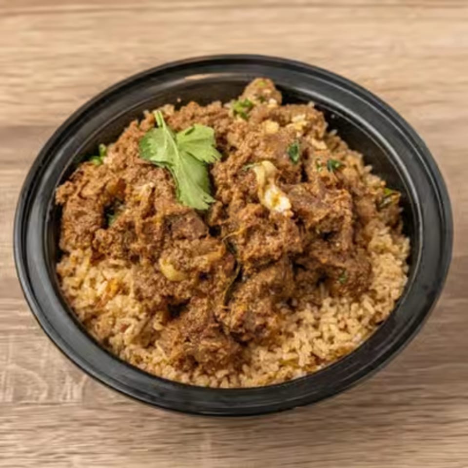 Kolapasi Indian Canteen's Indian mutton biryani, a flavorful rice dish with tender meat and fresh cilantro.